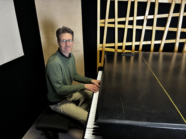 Matjaž Ferenc at the grand piano in a concrete studio