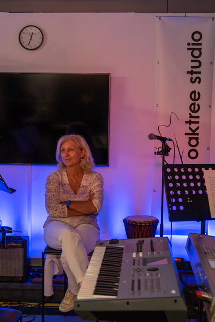Vocalist seated at Oaktree Studio
